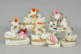 FIVE VARIOUS VICTORIAN AND LATER STAFFORDSHIRE POTTERY FIGURES OF SWANS AND ANOTHER OF BABES IN