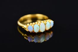 AN EARLY 20TH CENTURY FIVE STONE OPAL GRADUATED HALF HOOP RING, ring size P 1/2, approximate gross