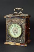 A LATE VICTORIAN/EDWARDIAN TORTOISESHELL AND SILVER MOUNTED CARRIAGE CLOCK, the circular enamel dial