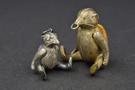 TWO EDWARDIAN NOVELTY SILVER ARTICULATED BEAR PIN CUSHIONS, both modelled with muzzles, the larger