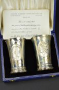 A CASED PAIR OF ELIZABETH II LIMITED EDITION SILVER WEDDING COMMEMORATIVE SILVER BEAKERS, with