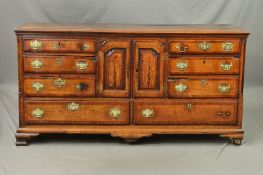 A GEORGE III OAK AND MAHOGANY BANDED DRESSER, in need of restoration, the triple plank top with