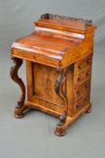 A VICTORIAN BURR WALNUT PIANO TOP DAVENPORT, fret carved moulding to the pop up top which encloses