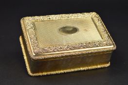A GEORGE V SILVER GILT RECTANGULAR TABLE BOX, the hinged cover cast with foliate scroll borders