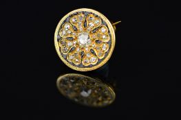 A GOLD LATE VICTORIAN SMALL ROUND DIAMOND SET BROOCH, a circular floral design, measuring