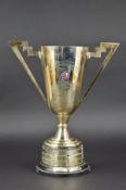 A GEORGE V SILVER CONICAL TWIN HANDLED TROPHY CUP, angular handles, presentation inscription 'Team