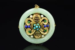 A 9CT GOLD JADE AND MULTI GEM PENDANT, of circular outline, the central 9ct gold panel of floral
