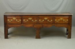 A GEORGE III OAK DRESSER, the triple plank top above four deep drawers with replacement brass swan
