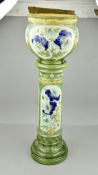 A BURMANTOFTS FAIENCE JARDINERE AND STAND, shape No.2050B, moulded in relief with blue poppies on