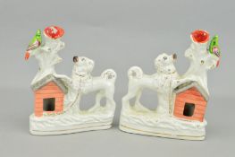 A PAIR OF VICTORIAN STAFFORDSHIRE POTTERY SPILL VASES, modelled as a pair of Spaniels with front