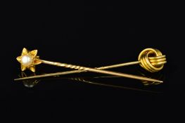 TWO STICKPINS, the first designed as a triple banded knot, the second an open star or flower