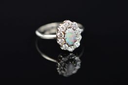 A MID TO LATE 20TH CENTURY OPAL AND DIAMOND OVAL CLUSTER RING, an oval grey/black opal displaying