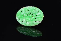 A MID 20TH CENTURY 9CT JADE BROOCH, an oval floral and foliate carved design, measuring