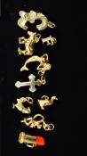 A COLLECTION OF MODERN ASSORTED 9CT GOLD CHARMS, to include a mermaid, swinging monkey, hen, pound