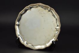A GEORGE III SILVER WAITER, gadrooned and pie crust rim, plain centre, on three cabriole legs with