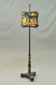 A VICTORIAN JAPANNED AND GILT DECORATED POLE SCREEN, the shaped square screen with scene of three