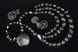 A JET NECKLACE AND THREE JET AND VULCANITE PANEL BROOCHES, the mid Victorian necklace designed as