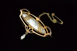 A GOLD ARTS & CRAFTS MOTHER OF PEARL BROOCH, suspending an oval form with fresh water pearl drop,