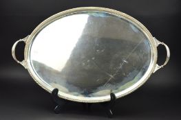 A GEORGE V SILVER OVAL TWIN HANDLED TRAY, gadrooned and beaded rim, reeded handles, makers William
