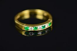 A MODERN 18CT GOLD DIAMOND AND EMERALD HALF ETERNITY RING, channel set in 18ct yellow gold,