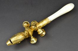A GEORGE III SILVER GILT RATTLE, with whistle, hinged loop, ten bells over two tiers, foliate