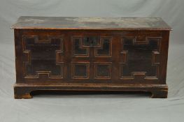 AN 18TH CENTURY OAK COFFER, the two plank hinged top over a triple panel front, on bracket feet,