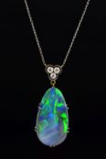 AN EDWARDIAN BLACK OPAL AND DIAMOND PENDANT, oval shape opal double claw set measuring approximately