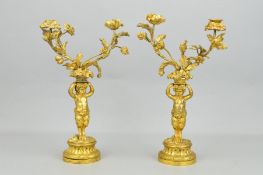 A PAIR OF 19TH CENTURY GILT METAL TWIN BRANCH CANDELABRA, the candleholders of flower head form,