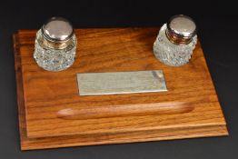 AN ELIZABETH II WALNUT DESK STAND, of rectangular form, moulded pen rest inset rectagular silver