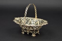 A GEORGE III SILVER WAVY OVAL SWEETMEAT BASKET, the swing handle formed of interlinked ovals and