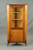 AN EVEREST TEAK GLAZED 1950'S CORNER CABINET, above a further door featuring geometric detail,