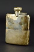 A GEORGE V/VI SILVER HIP FLASK, of bowed rectangular form, bayonet fitting to hinged cover (dented),