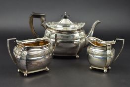 A LATE VICTORIAN SILVER THREE PIECE TEASET, of shaped oval form, gadrooned rims, banded and