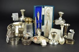 A PARCEL OF ASSORTED SILVER, to include two ashtrays, two vesta cases, assorted napkin rings, a