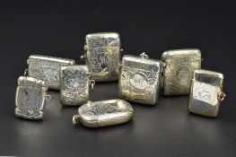 EIGHT SILVER VESTA CASES, one plain engraved with inscription, the other seven with foliate engraved