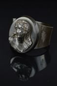 A LATE VICTORIAN VULCANITE BANGLE, designed as a central oval carved cameo depicting a lady to the