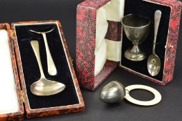 A CASED ELIZABETH II SILVER EGG CUP AND SPOON, engraved initials, makers Walker & Hall, Sheffield