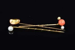 THREE STICKPINS, the first designed with a central coral cabochon flanked by a seed pearl and a