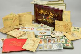 A COLLECTION OF CIGARETTE CARDS, in 22 'One Penny' albums and two old cardboard albums to include
