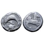 Calabria, Tarentum AR Sixth-Stater. Circa 500-480 BC. Dolphin leaping left over pellet and cockle