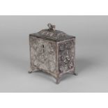 An Indian tea caddy, with lion finial, embossed with figures, raised on winged paw feet, unmarked,