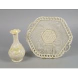 A Belleek porcelain pierced hexagonal basket, with scrolling handles and a woven edge, the centre of