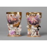 A pair of Berlin KPM goblets, 19th century, decorated with shaped vignettes of cherubs in clouds