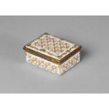 A Berlin porcelain rectangular box, 18th century, applied with borders of raised gilt work to the