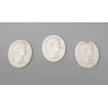 Three oval glass plaques of Roman Emperors, 19th century, moulded in profile, with names below for T