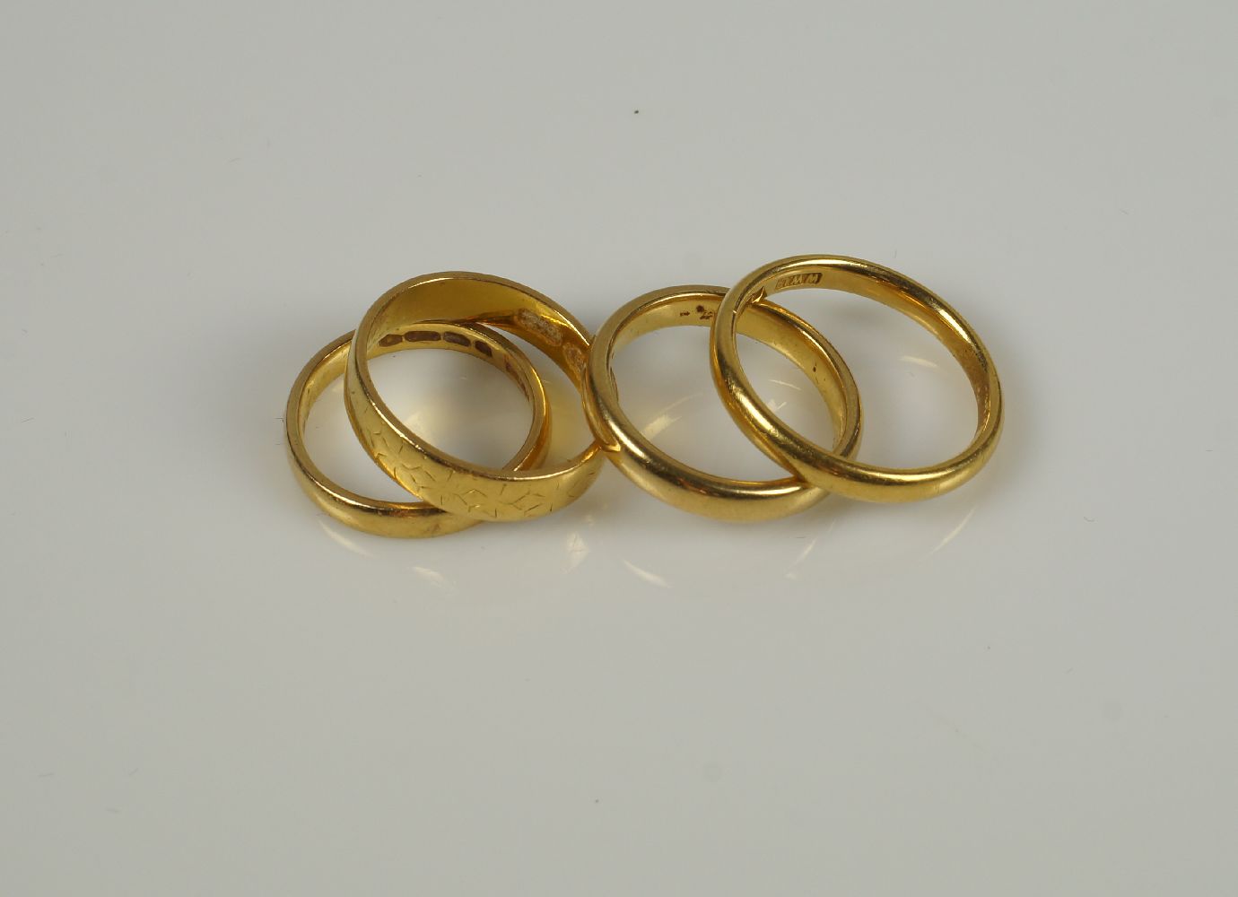 Four 22ct. gold band ringsTotal weight approx. 15.5g, (4)