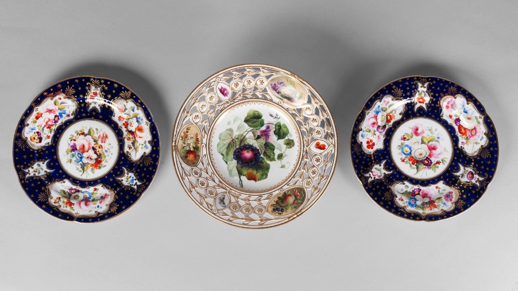 An English porcelain reticulated painted and gilt tazza, 19th century, the pierced rim inset with