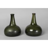 Two Georgian green glass onion form bottles, 18.5cm high (2)