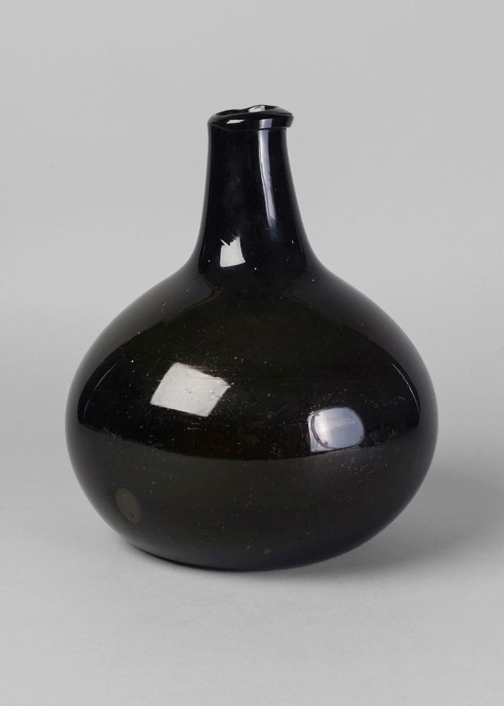 A large green glass onion shaped bottle, 18th century, 29cm high