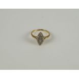 An Edwardian diamond ringDesigned as an old-brilliant-cut navette cluster with bifurcated shoulders,